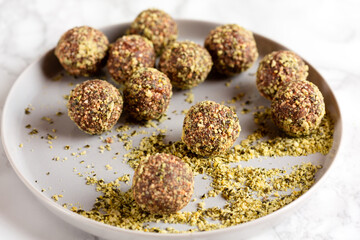  Date and nuts energy balls rolled in pumpkin seeds fine dust