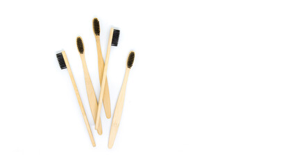 eco-friendly bamboo toothbrushes in black color lie on a white background. Flat lay, top view. Copy space. Zero waste personal care product, dental care