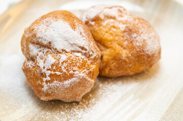 Two cream carnival pancakes or carnival fritters, italian traditional sweet