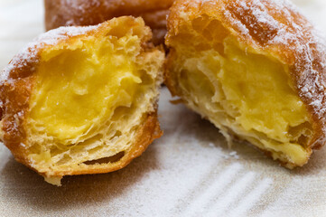 Two cream carnival pancakes or carnival fritters, italian traditional sweet