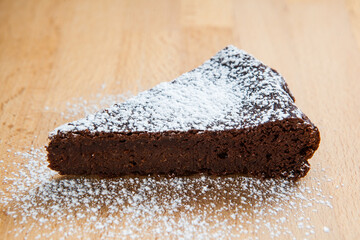 delicious chocolate cake resting on a wooden cutting board