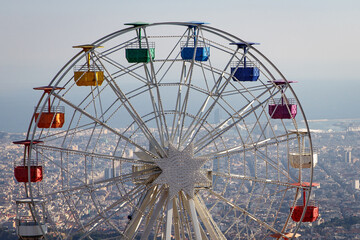 Ferris wheel in Tibidabo with panoramic view over Barcelona