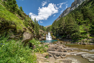 Waterfalls of the river Ara in the Ordesa valley on a sunny day.