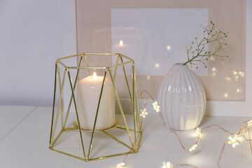 Two unopened hyacinths in a glass vase with artificial ice. Interior view in modern scandinavian style with painting canvas or poster on the wall. Living room, chest of drawers with vases.