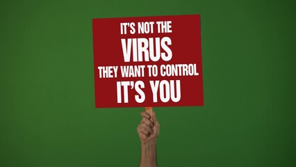 Hand holding sign banner with text Say No To Medical Tyranny in protest of covid 19 vaccine stop immunization no tax concept on green screen.