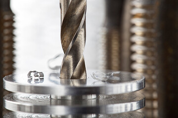 metal drill bit make holes in aluminium radiator on industrial drilling machine. Metal work...