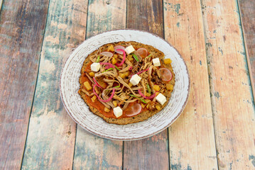 Hawaiian pizza is a pizza that contains a base of melted cheese and tomato that are dressed with ham and pineapple