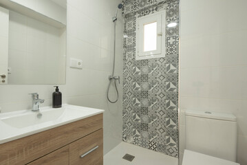 Full bathroom with shower with hydraulic tile wall, glass partition, wooden bathroom cabinet and...