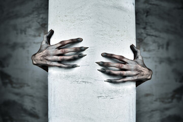 A Pair of Scary Hands Reach Out from Behind a COlumn - obrazy, fototapety, plakaty