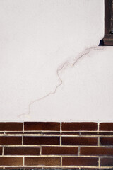 A crack in the wall by the window.