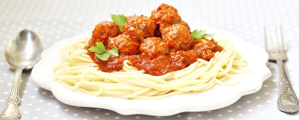 pasta with meatballs in tomato sauce on a light background, copy space
