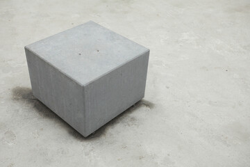 Urban architecture concept. Gray cube with cement on concrete background. Minimalism style. Copy-space. Outdoor shot