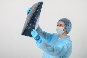 a nurse in a medical gown, mask and protective gloves