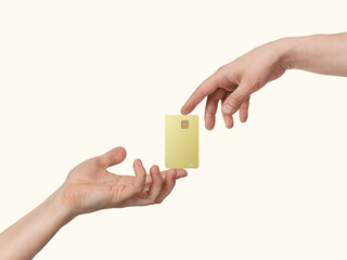 Hands keep gold bank card in spotlight, isolated on beige background