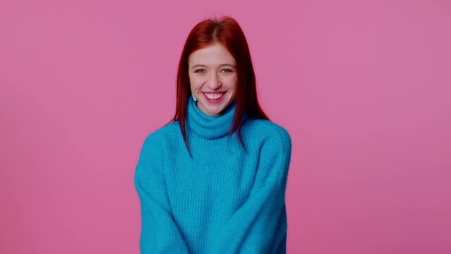 Wow. Hello, welcome. Portrait of happy excited young teenager girl appear from below waving hi with her palm, greeting with hospitable friendly smile. Indoor studio shot isolated on pink background