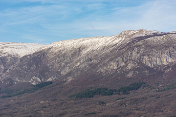 Fototapeta na wymiar Landscape view of Suva Planina in Serbia on a winter day. The top of mountain is covered with snow