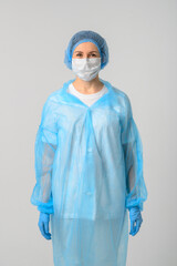 Doctor or nurse in a medical gown, mask and protective gloves