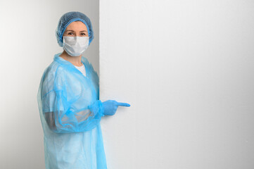 Doctor or nurse in a medical gown, mask and protective gloves