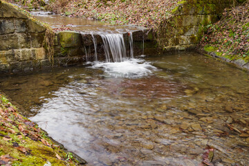 A small artificial waterfall made of stones.