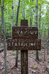 Virginia and West Virginia State Line Wooden Sign in Forest