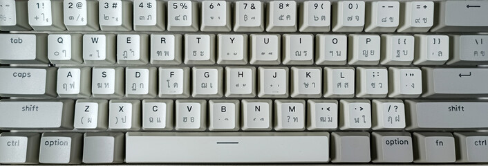 White keyboard background with Thai and English on the keypad