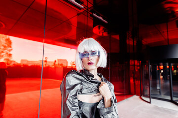 Fashion portrait of a blonde on a red background.