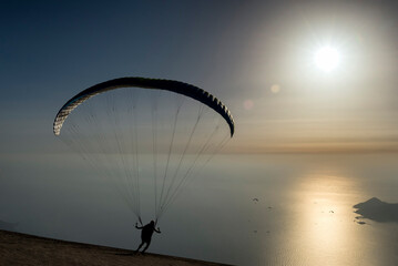 Silhouette of a man at the paragliding ramp
