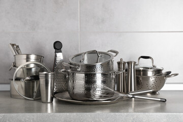 Set of different cooking utensils on grey countertop in kitchen - obrazy, fototapety, plakaty