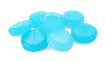 Many light blue cough drops on white background