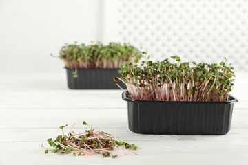 Fresh radish microgreens on white wooden table