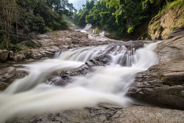 Fototapeta premium Silky smooth view of river flows at Chamang Waterfalls, Bentong, Pahang, Malaysia