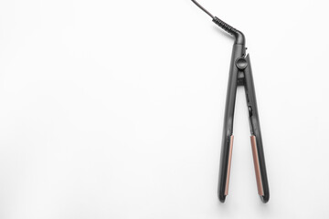 Modern corrugated hair iron isolated on white, top view