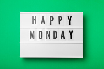 Light box with message Happy Monday on green background, top view