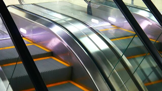 Close-up of the top of two beautiful escalator tracks with reversible movement