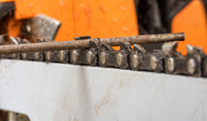 Chainsaw chain sharpening with file. Closeup macro shot
