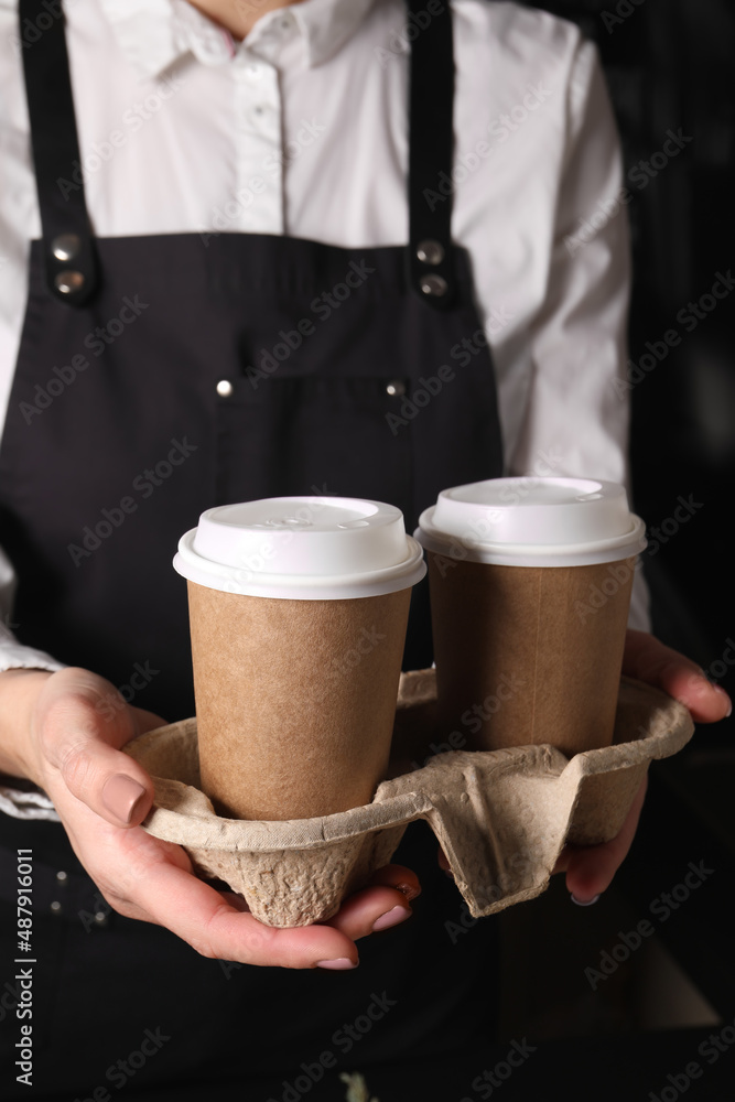 Canvas Prints Barista holding takeaway paper cups with coffee in cafe, closeup