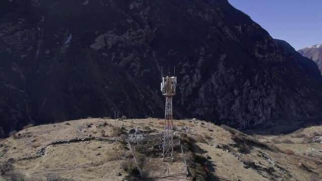Circling around a radio tower in Langtang with solar energy in Nepal in the Himalayan mountains near small village.