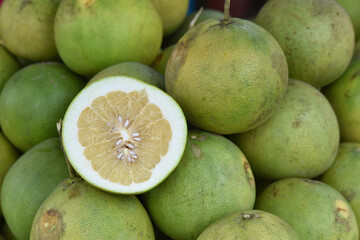 Close-up photo of pomelos in market. The pomelo is commonly consumed and used for festive occasions...
