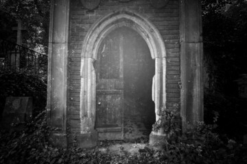 The crypt door in the cemetery. - obrazy, fototapety, plakaty