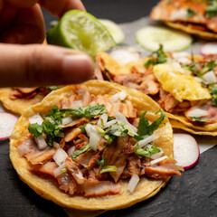 Pork tacos called al pastor with pineapple and sauce. Mexican food