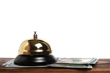 Gilded bell hotel service and hundred dollar bills on wooden reception desk hotel.Conceptual hotel, travel and recreation.