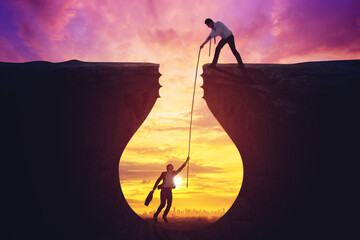 Businessman help his partner to out from the hole - obrazy, fototapety, plakaty