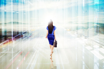 Fototapeta na wymiar Businesswoman walking toward bright light