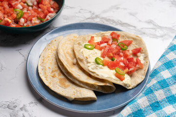 Quesadilla with fresh sauce called pico de gallo. Mexican food