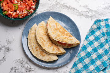 Quesadilla with fresh sauce called pico de gallo. Mexican food