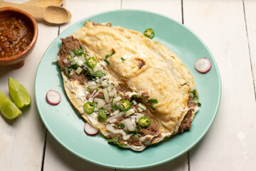 Quesadilla with beef barbacoa and sauce. Mexican food