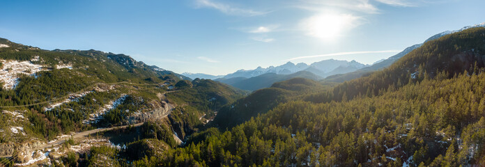Aerial Panoramic View of Sea to Sky Highway in a valley by mountains. Sunny Winter Day. Located...