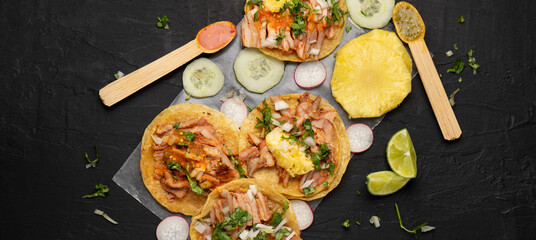 Pork tacos called al pastor with pineapple and sauce. Mexican food