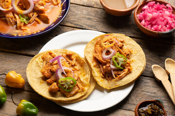 Cochinita pibil tacos with habanero pepper and purple onion. Mexican food