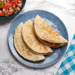 Quesadilla with fresh sauce called pico de gallo. Mexican food